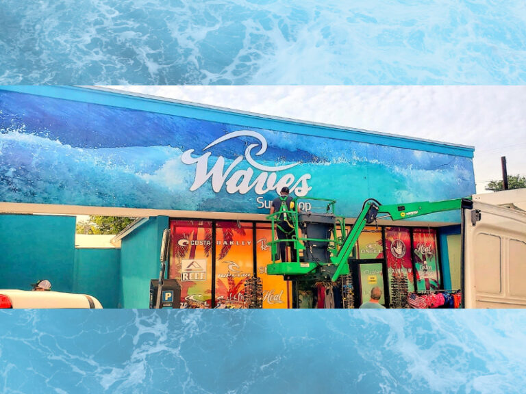 Retail storefront covered with ocean-themed window graphics
