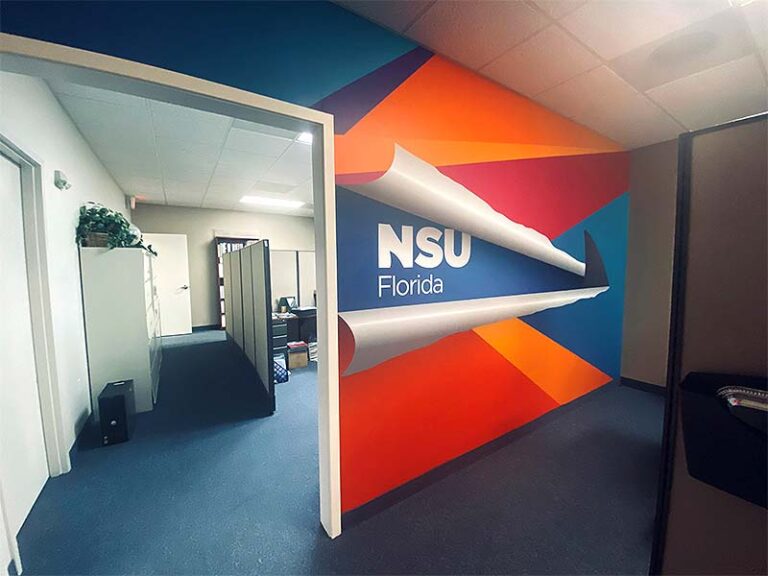 NSU Florida dimensional logo mounted over geometric wall graphics