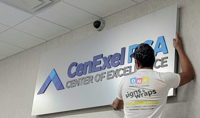 Installer mounting a CenExel RCA dimensional wall sign