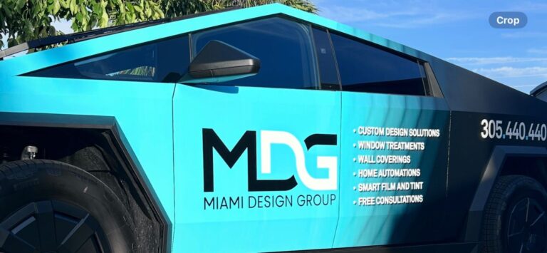 Miami Design Group vehicle wrapped with turquoise and black graphics
