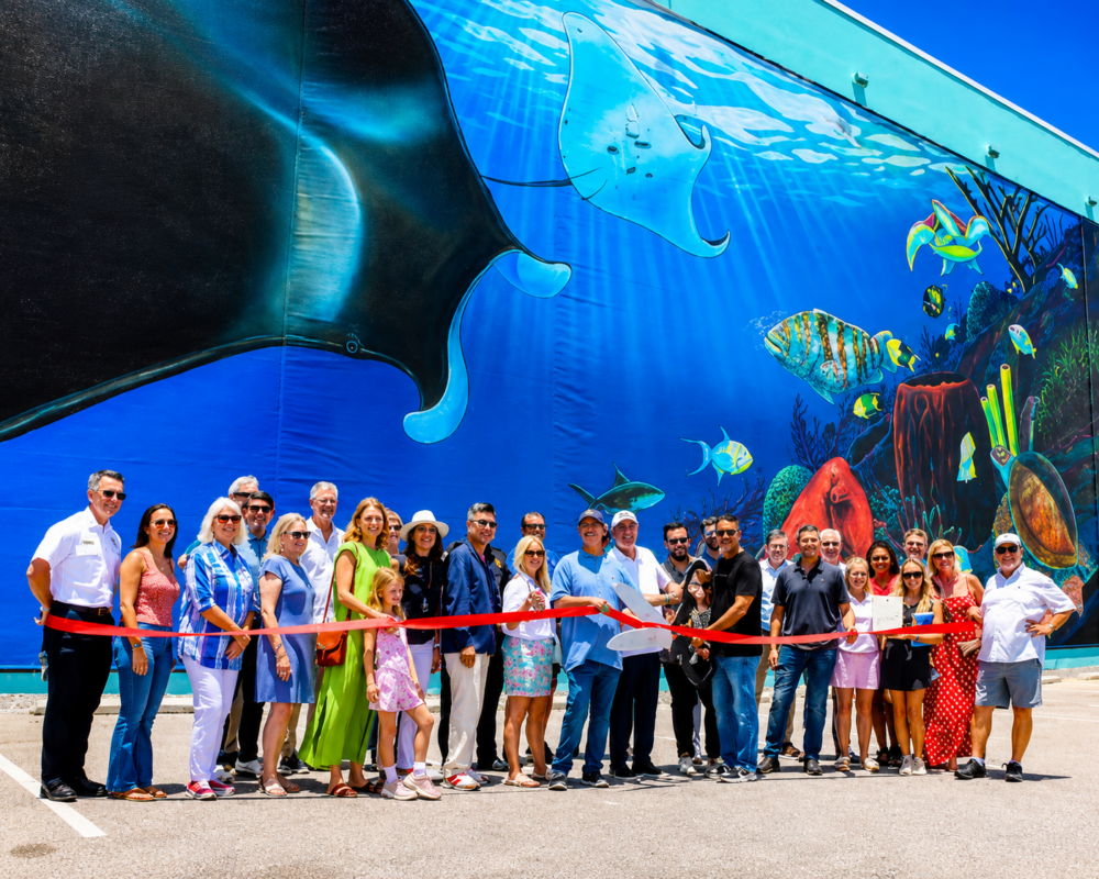 Wyland mural installation at Surf Style featuring large-format ocean-themed wall graphics produced and installed by DNA Marketing & Printing in Clearwater Beach and Gulf Shores